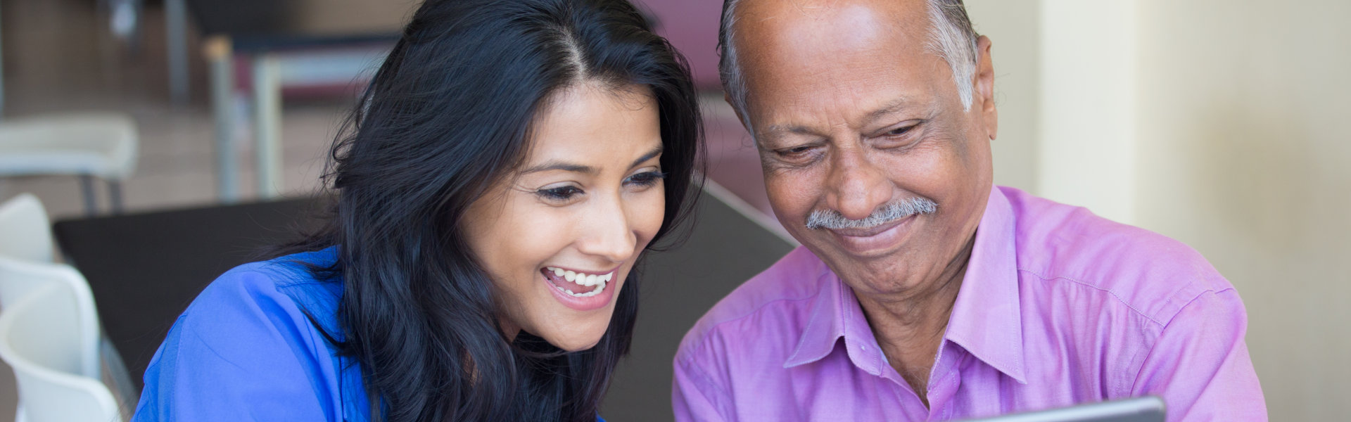 Young women and elderly man smiling